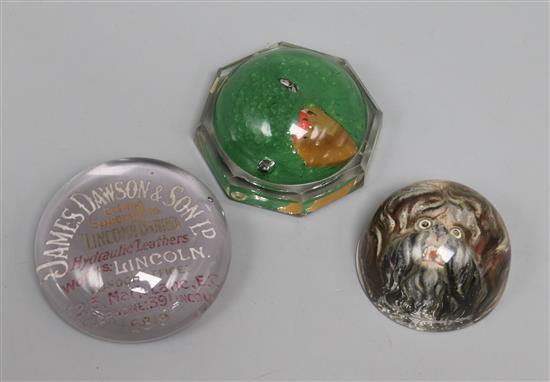 Three Victorian reverse intaglio moulded glass paperweights; parrot, dogs head and James Dawson & Son advertising